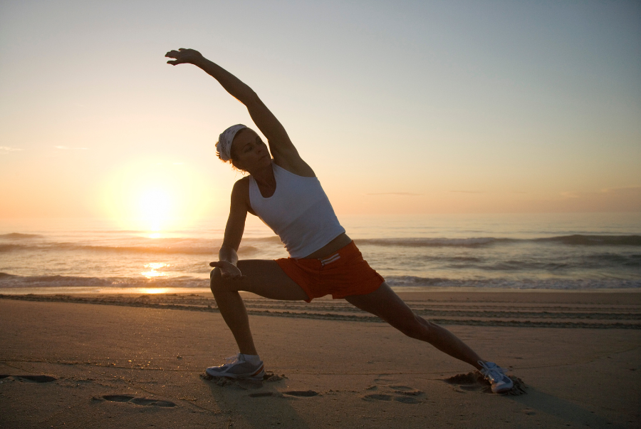 Person stretching at Yorktown Beach for herniated disc Symptoms rehab